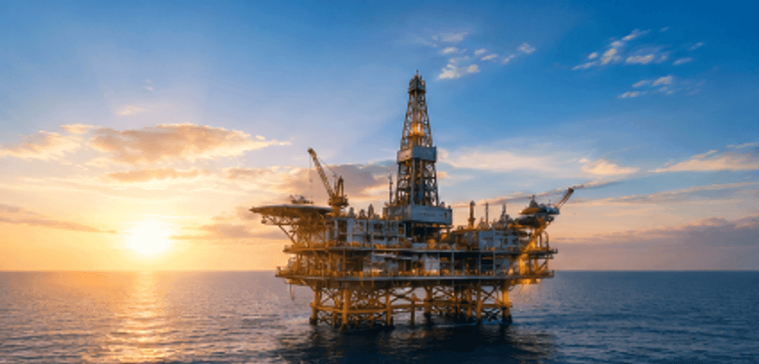 Offshore drilling rig platform in calm waters during golden hour